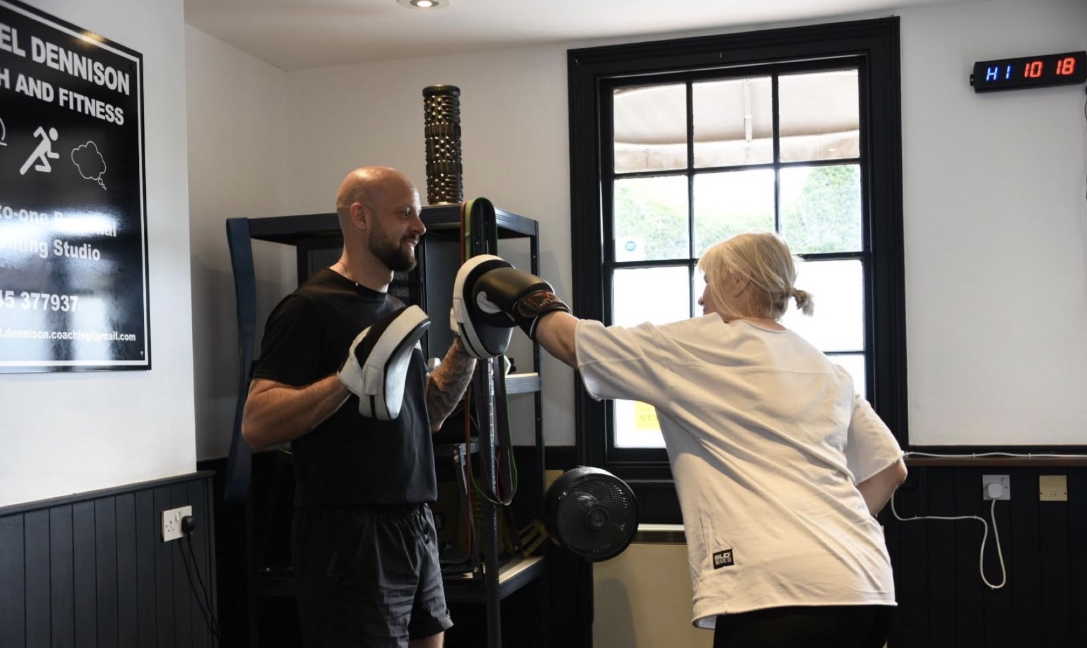 Michael Dennison coaching a client on the pads in his private studio